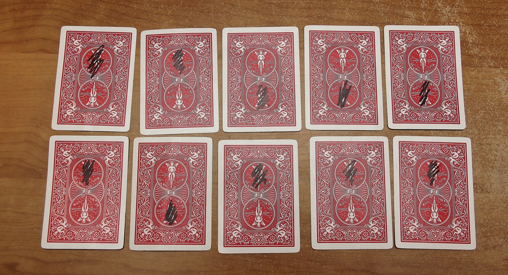 10 playing cards face down, 5 in the top row and 5 in the bottom row.